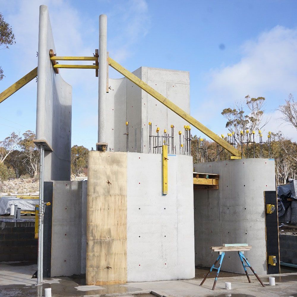 A Construction Site With Concrete Walls and a Wooden Door — Vale Building Inspections in The Entrance, NSW