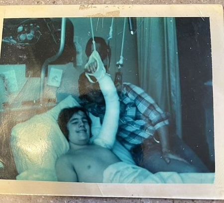 man in hospital with arm sling