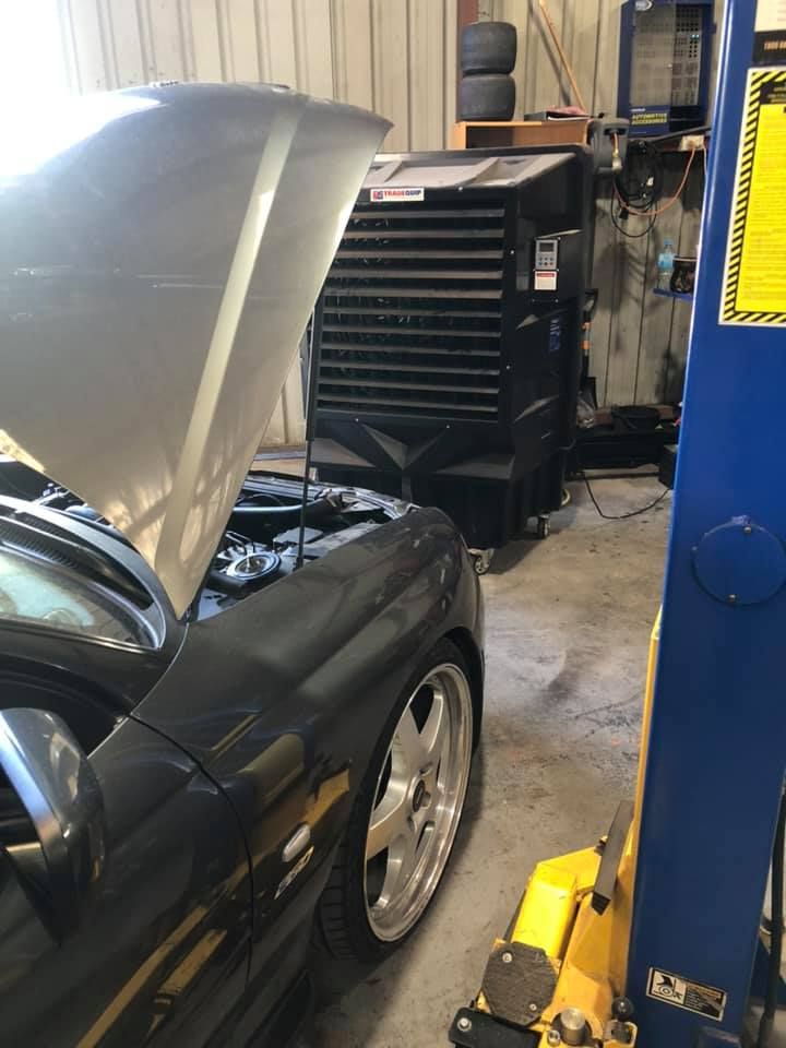 A Car With the Hood Up is on a Lift in a Garage — Jon Wilson Mechanical in Eaglehawk, VIC