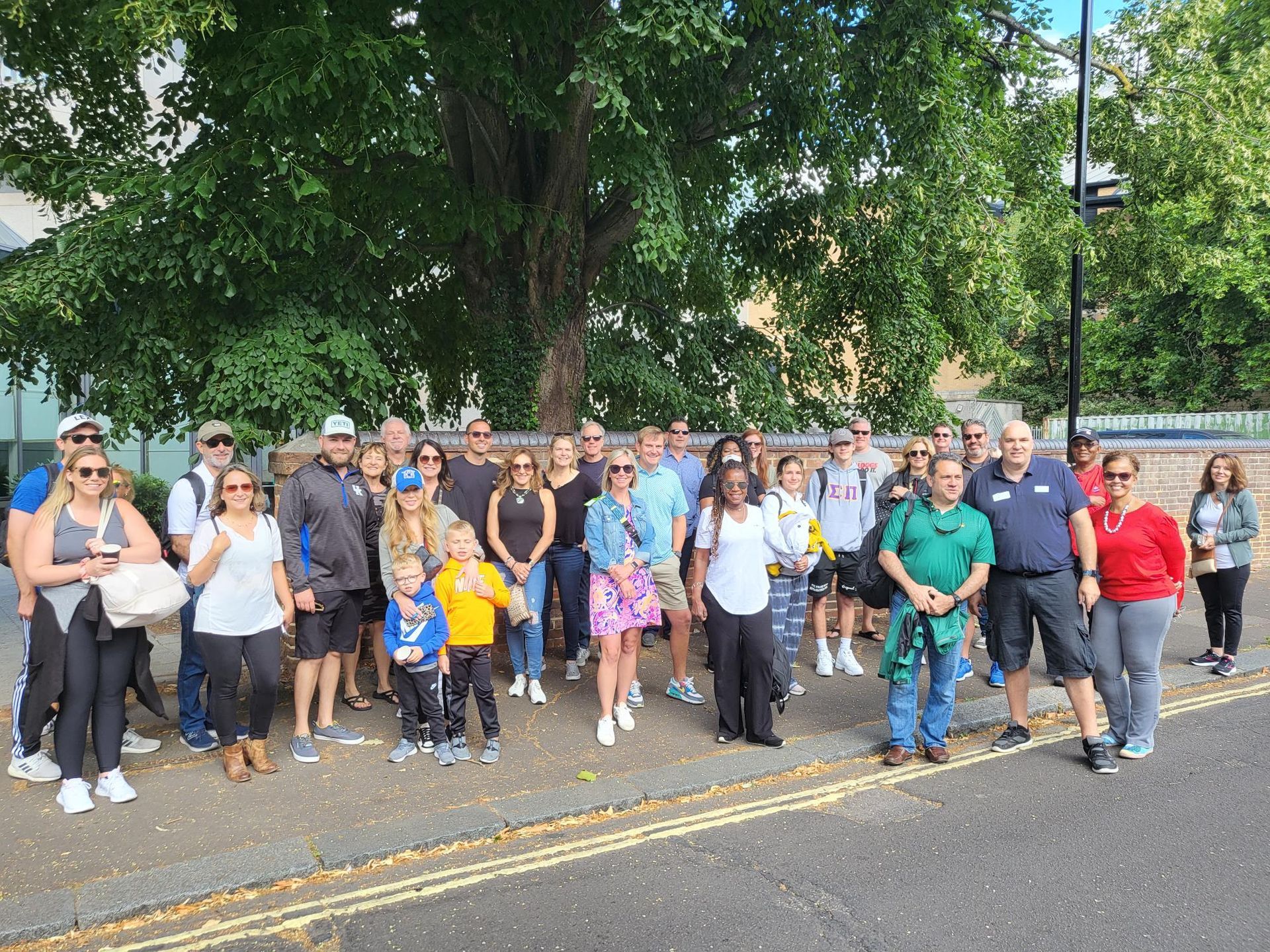 A large group of people are standing on the side of the road.