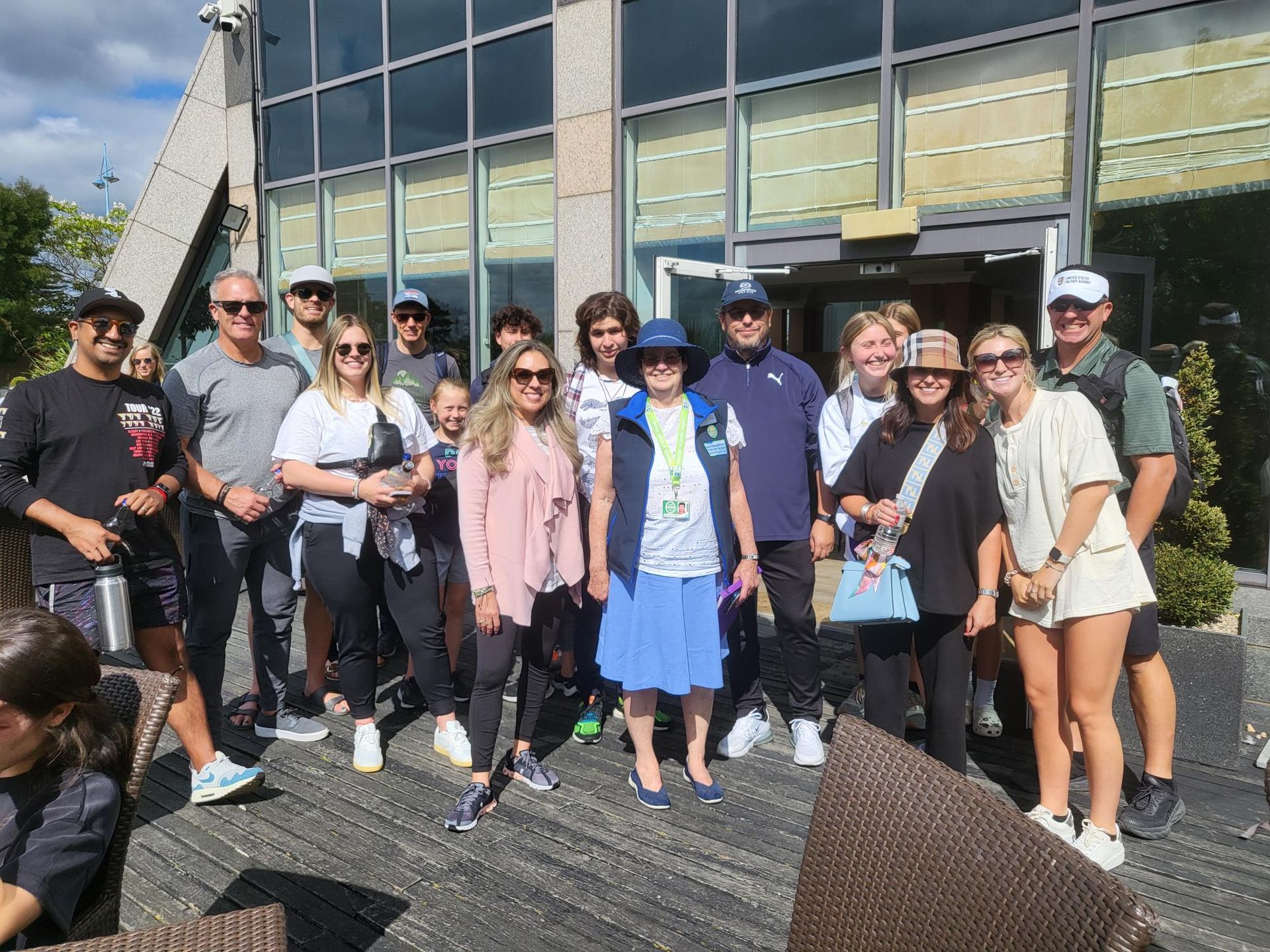 A group of people are posing for a picture in front of a building.