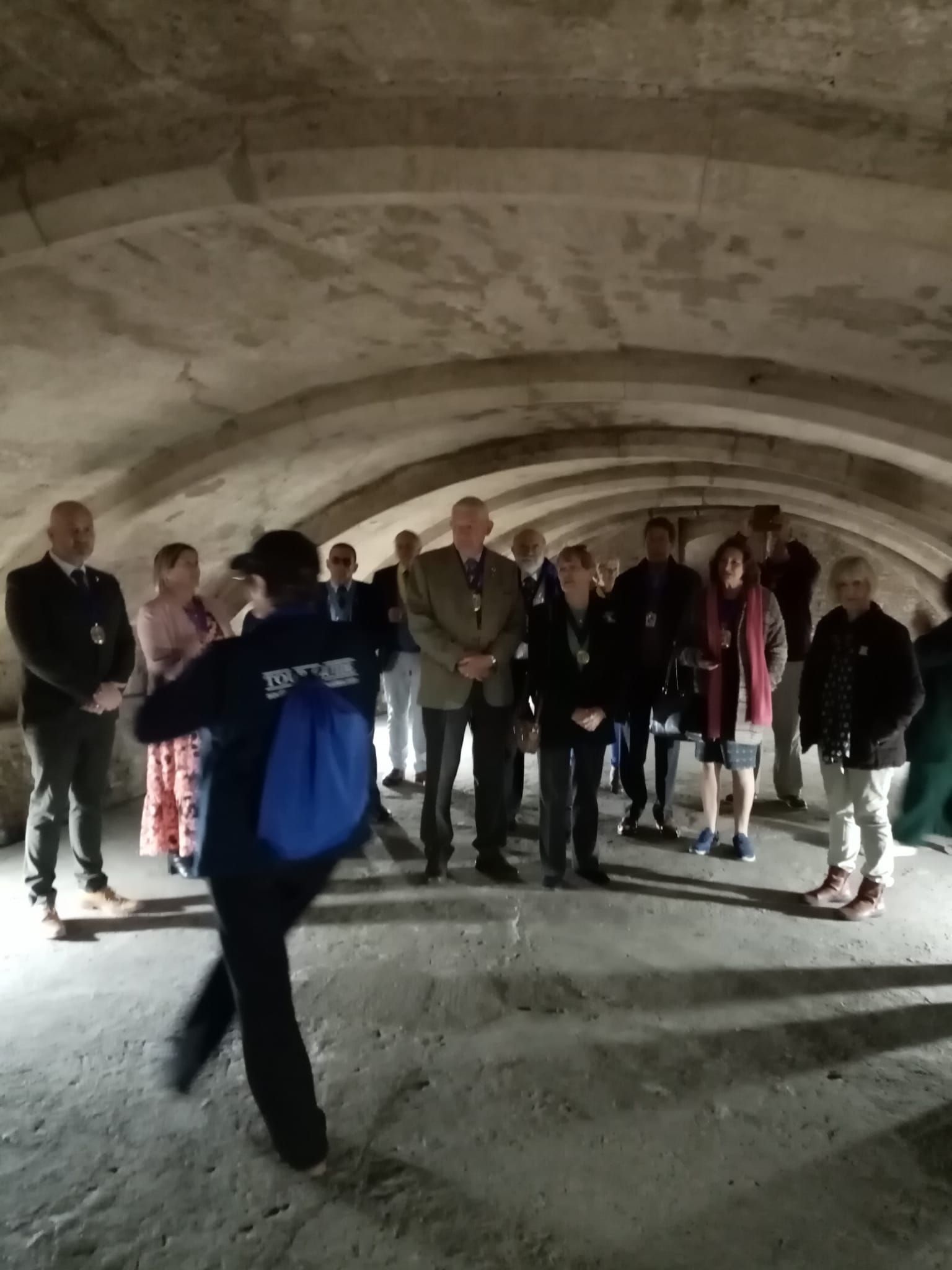 A group of people are standing in a dark room.