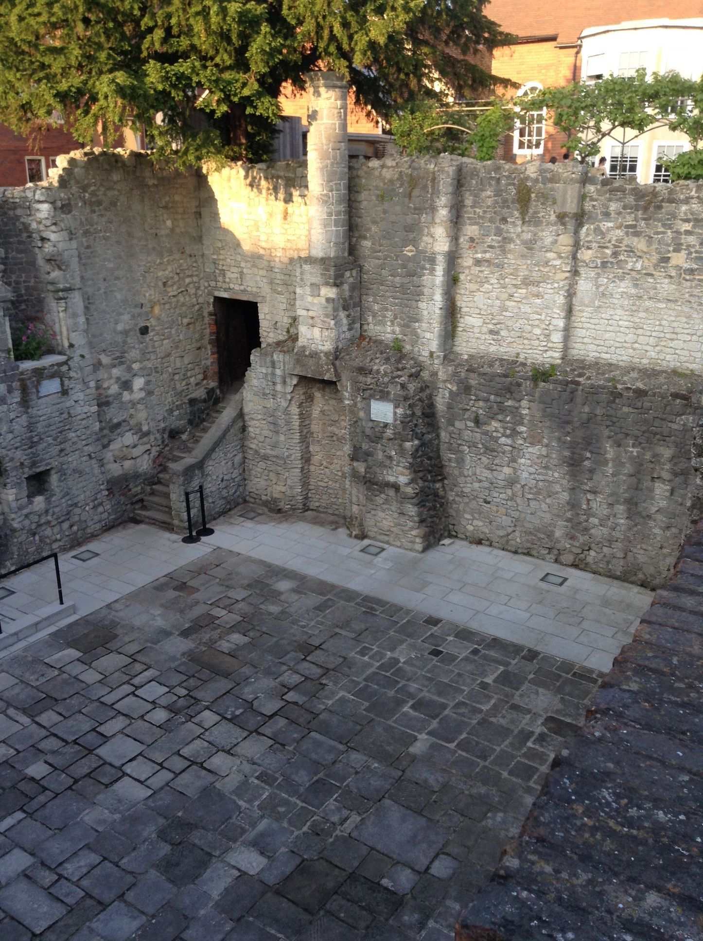 A stone wall with stairs leading up to it