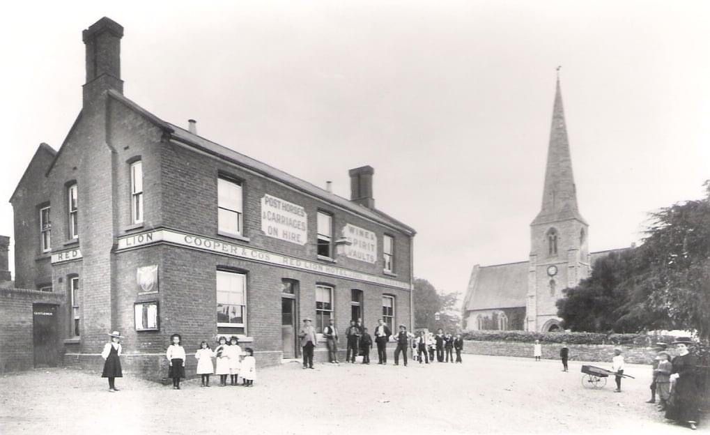 A black and white photo of a church and a brick building