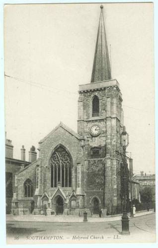 A black and white photo of a church with a clock tower.