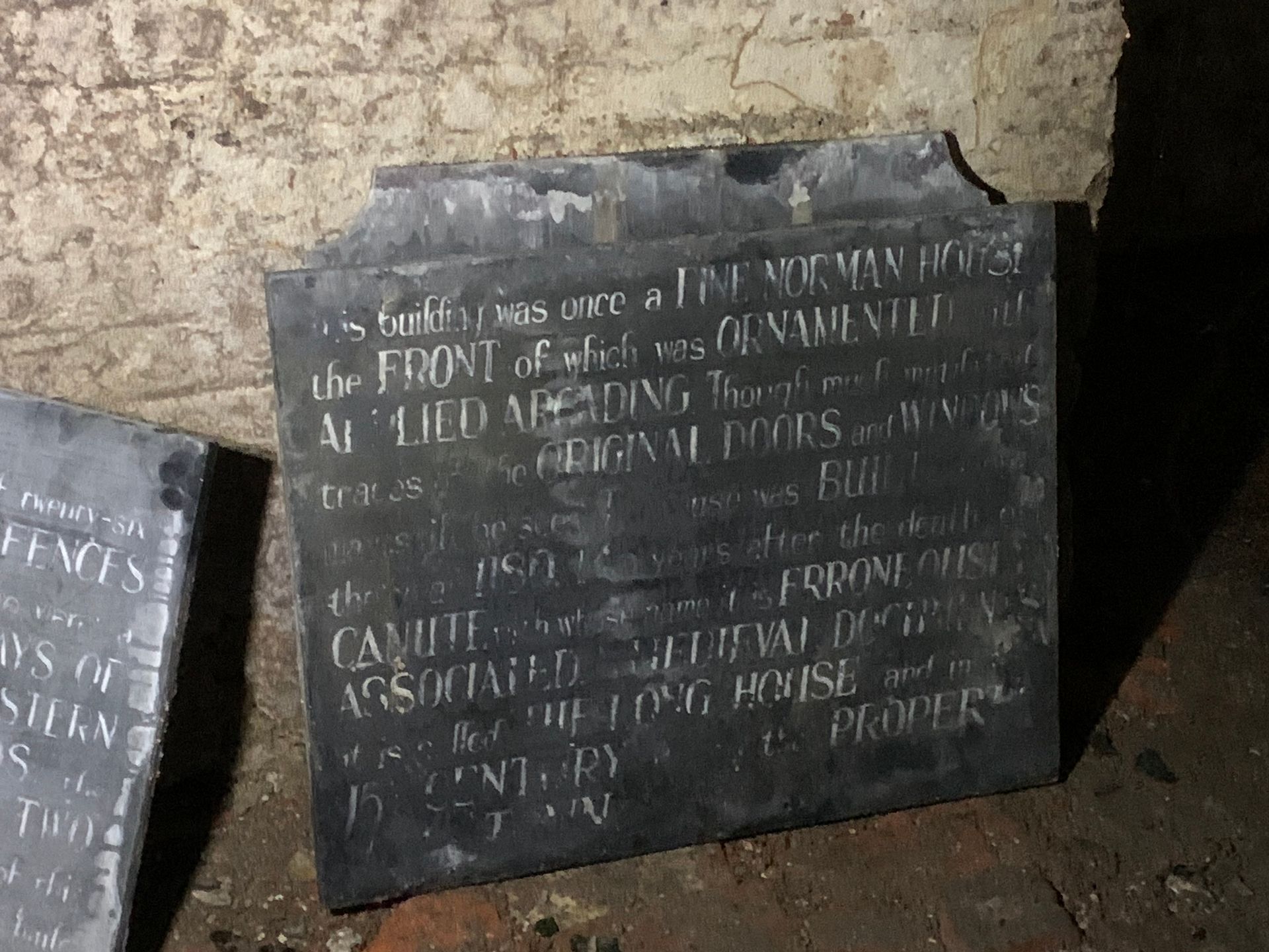 A plaque on the ground that says ' the front ' on it