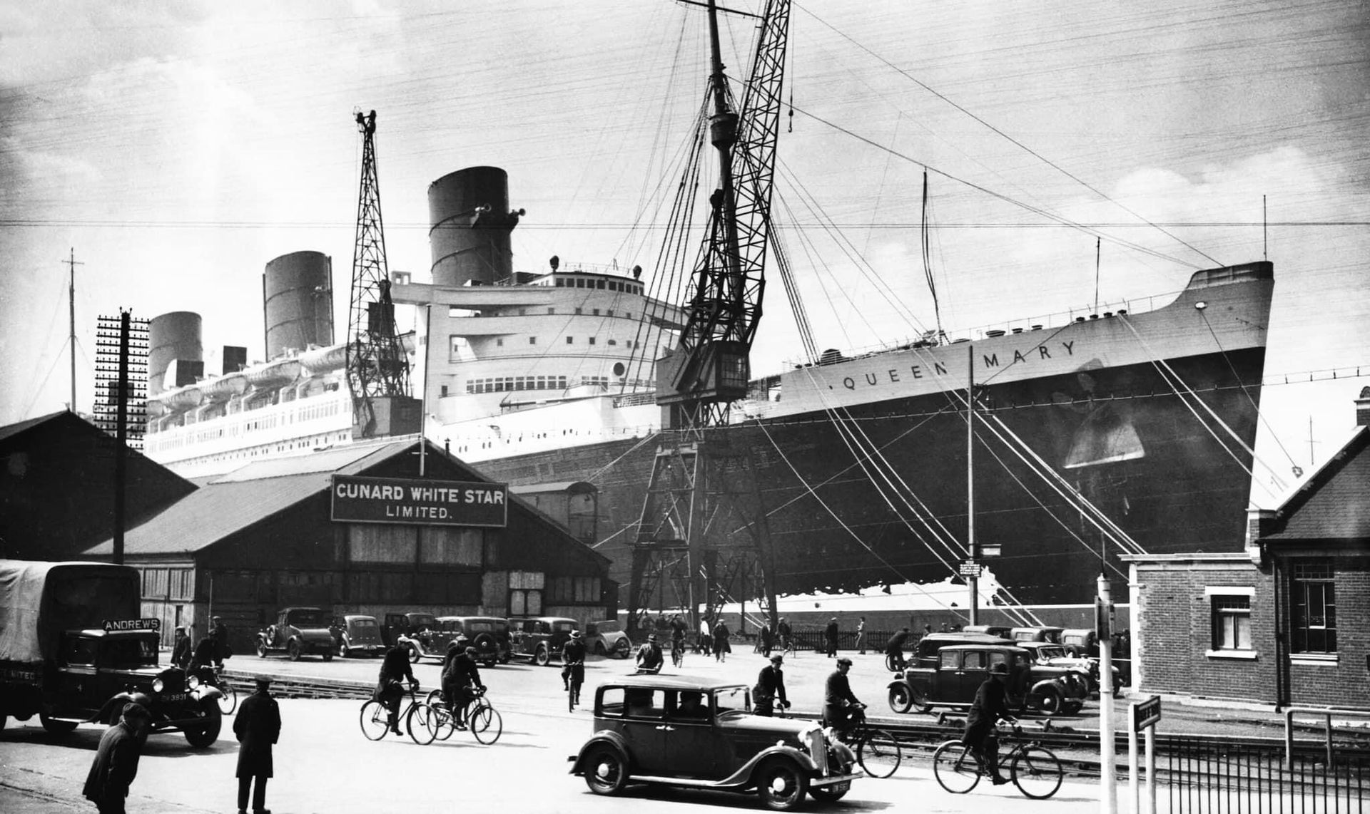 A black and white photo of a large ship in a harbor