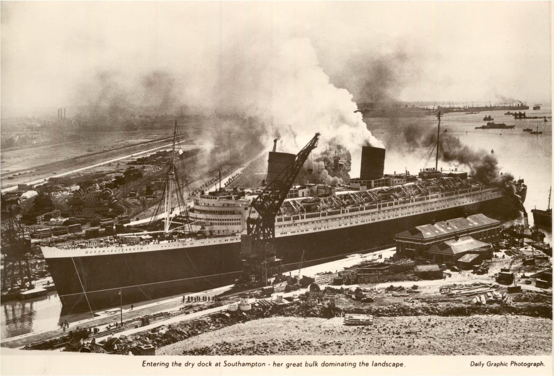 A black and white photo of a large ship in a harbor