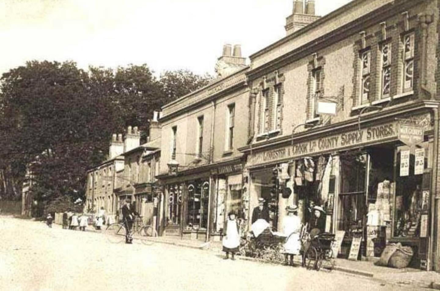 A black and white photo of a row of shops