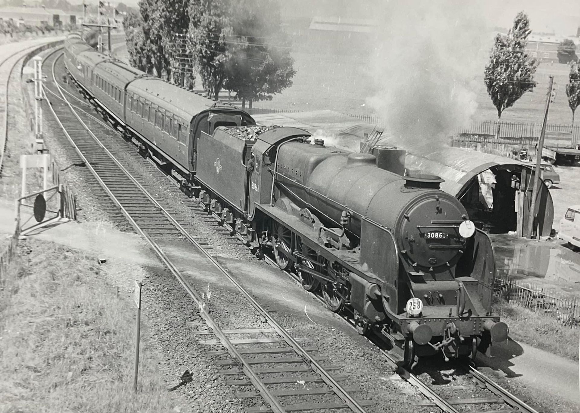 A black and white photo of a train on the tracks