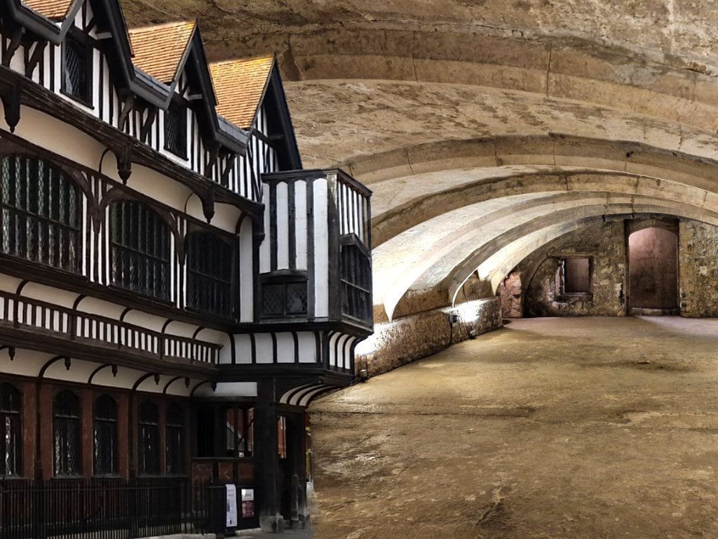 A group of people standing on a brick sidewalk holding umbrellas.