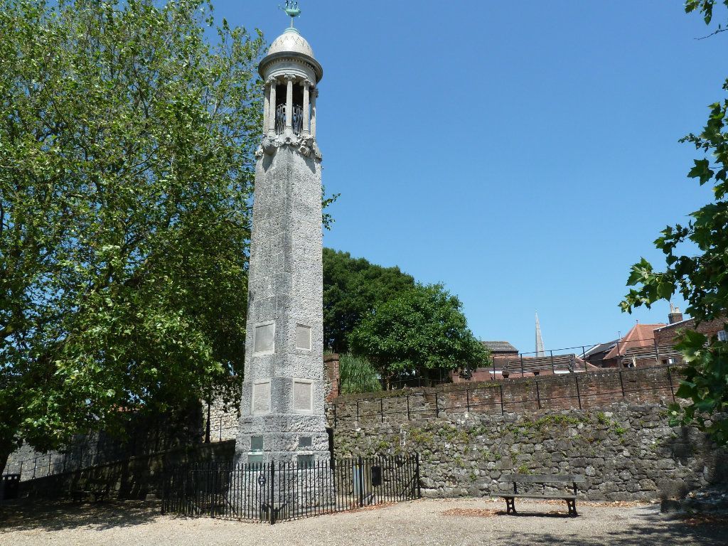 A tower with a dome on top of it is surrounded by trees