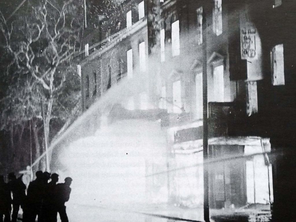 A black and white photo of a fire in a building with a sign that says ' a ' on it