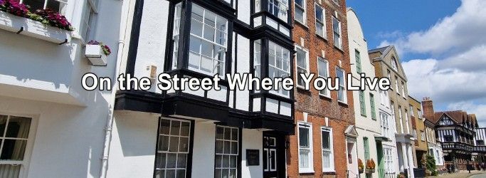 A row of buildings with the words `` on the street where you live '' written on them.