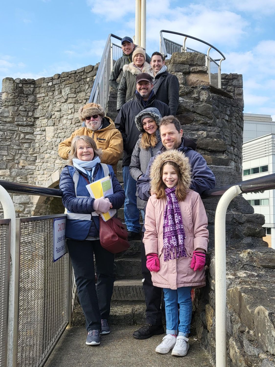A group of people are standing on a set of stairs.