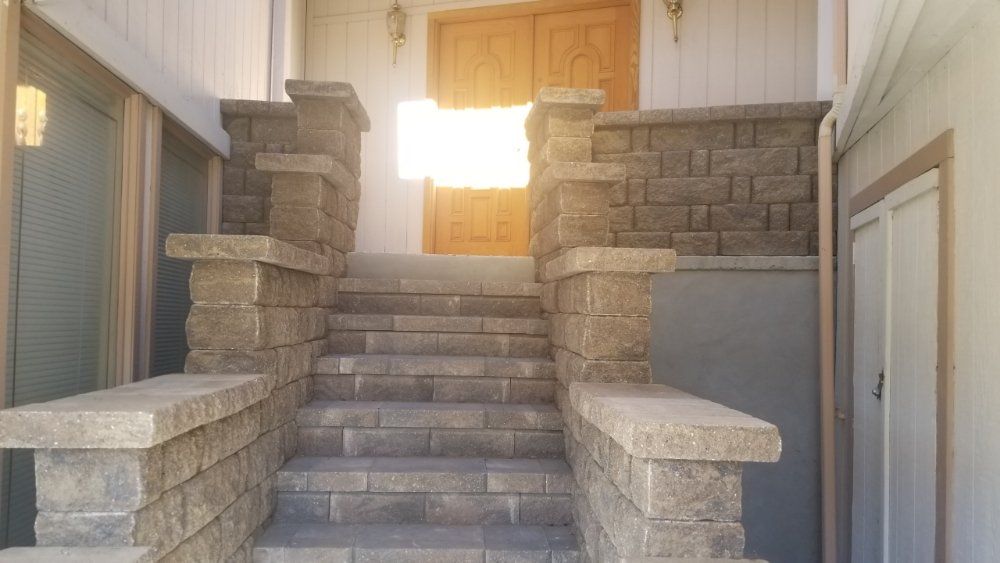 A set of stairs leading up to the front door of a house.