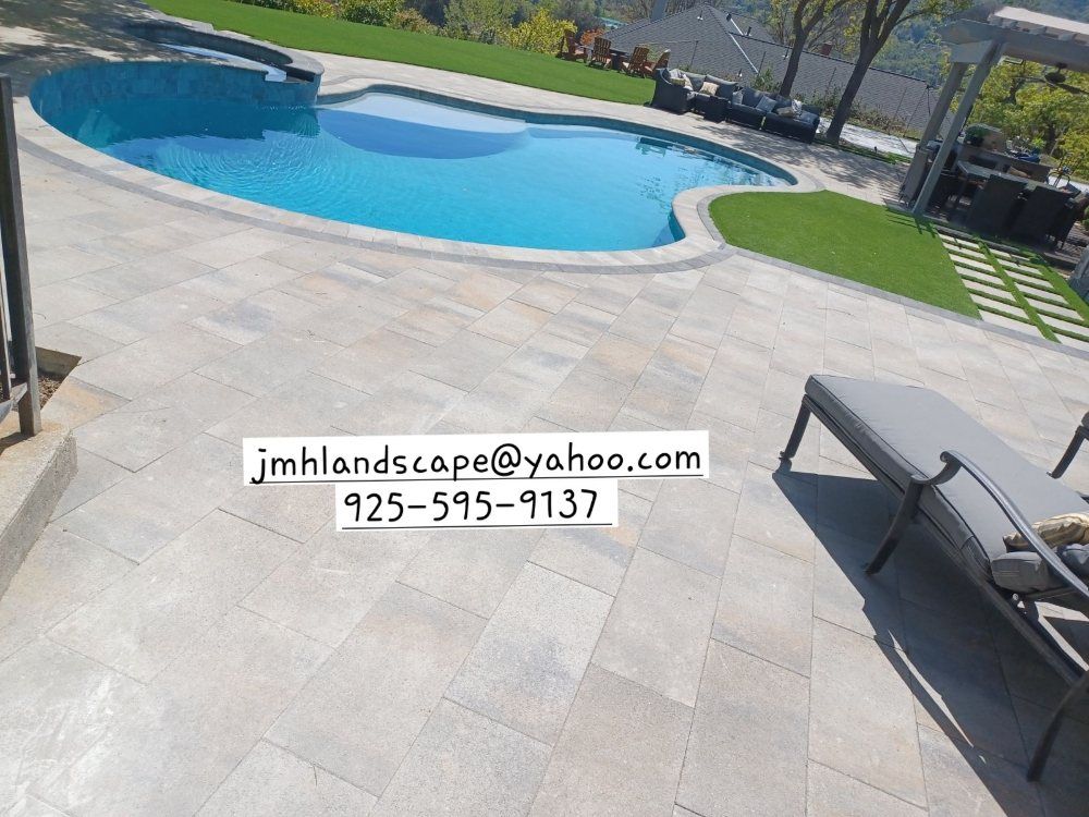 A large swimming pool is in the backyard of a house