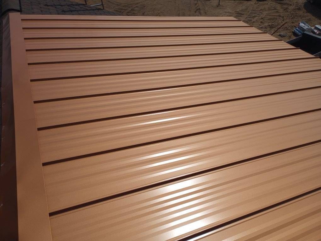 Brown corrugated metal roof panels on a building under construction