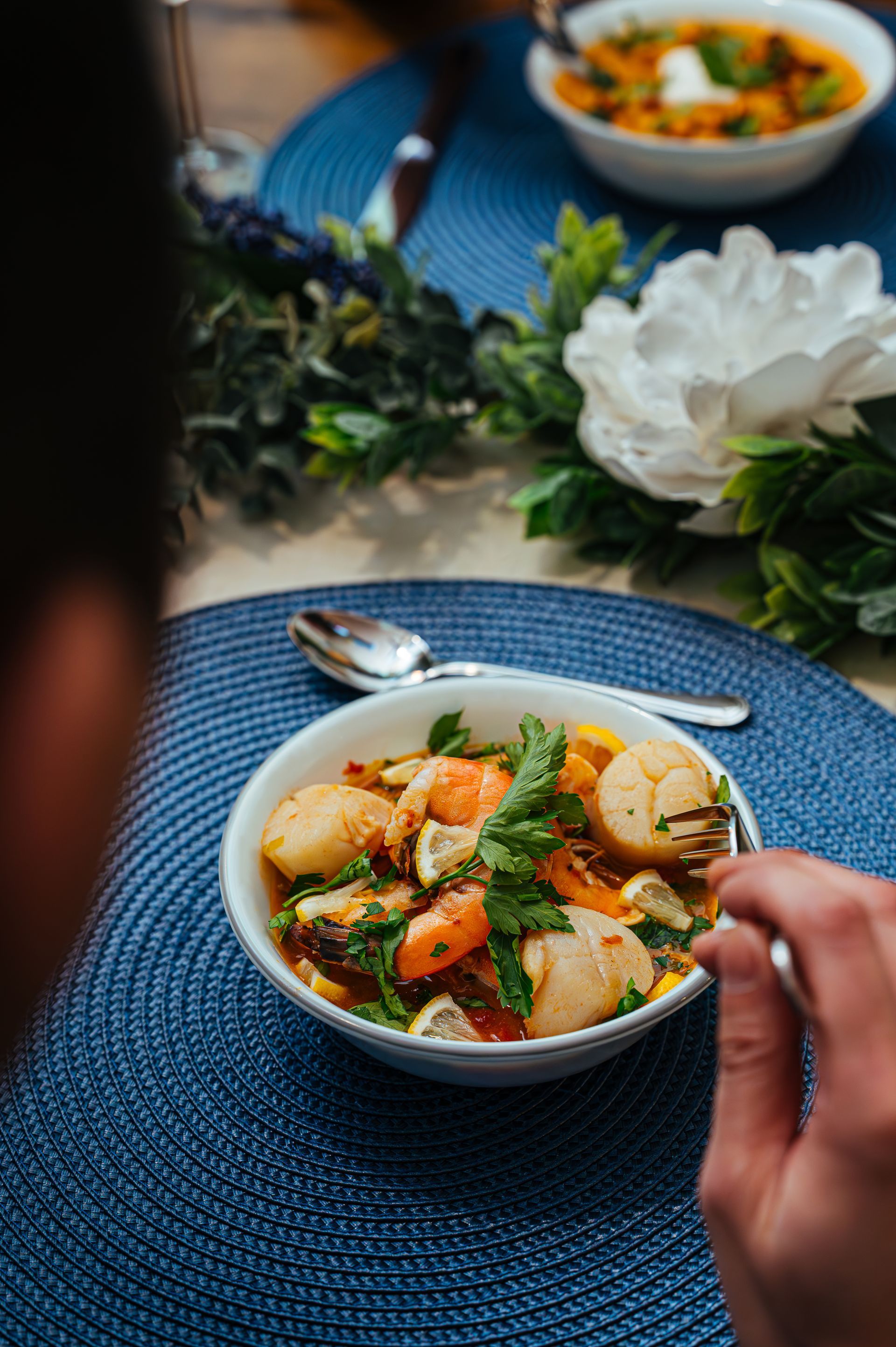 Happy couple enjoying a cozy moment in a cottage, raising a toast with a glass of wine and beer.
