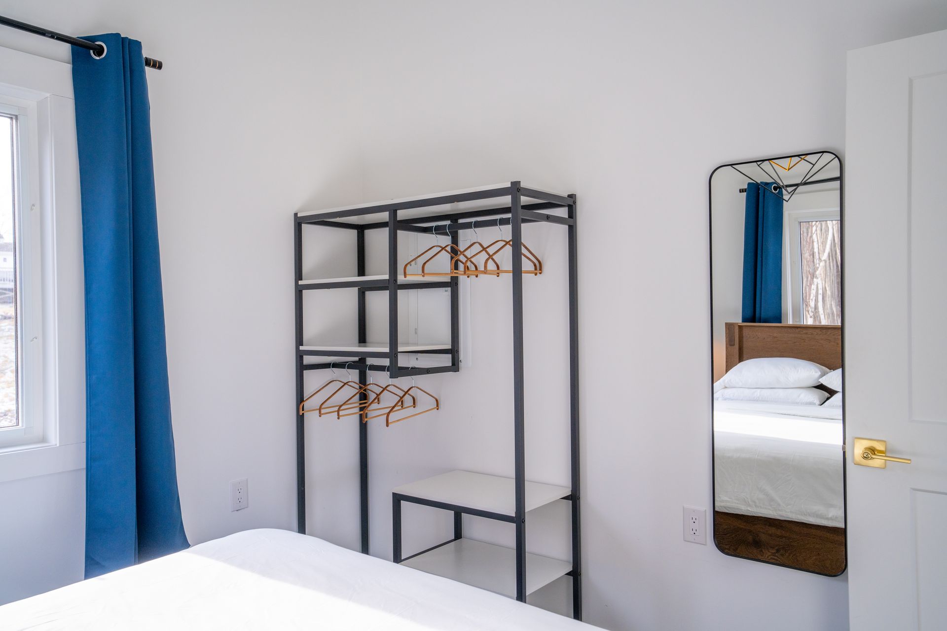 Bright bedroom, with white queen bed and nightstands.