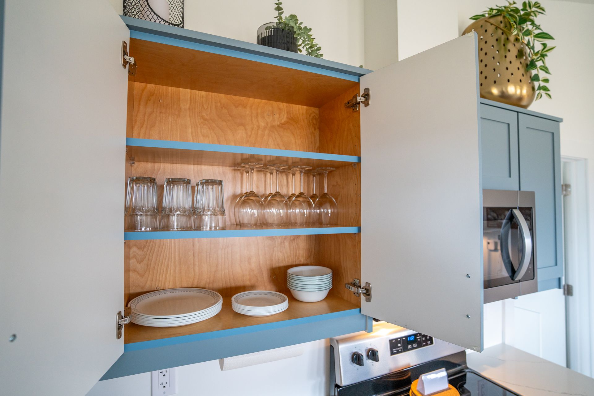 cupboard full of dinnerware 