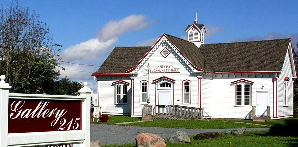 A art gallery named gallery 215, an old white school house with red trim
