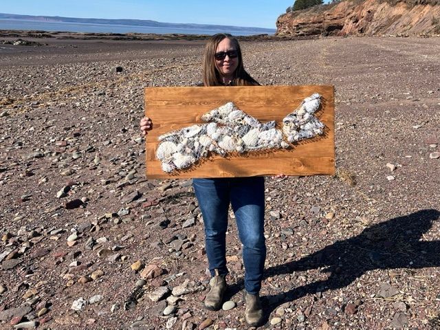 Happy couple enjoying a cozy moment in a cottage, raising a toast with a glass of wine and beer.