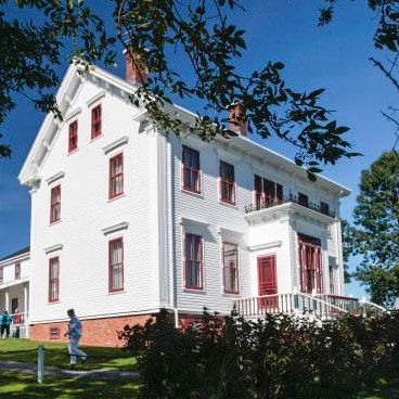 Large white with red trim historic ship builders mansion, the Lawrence house museum