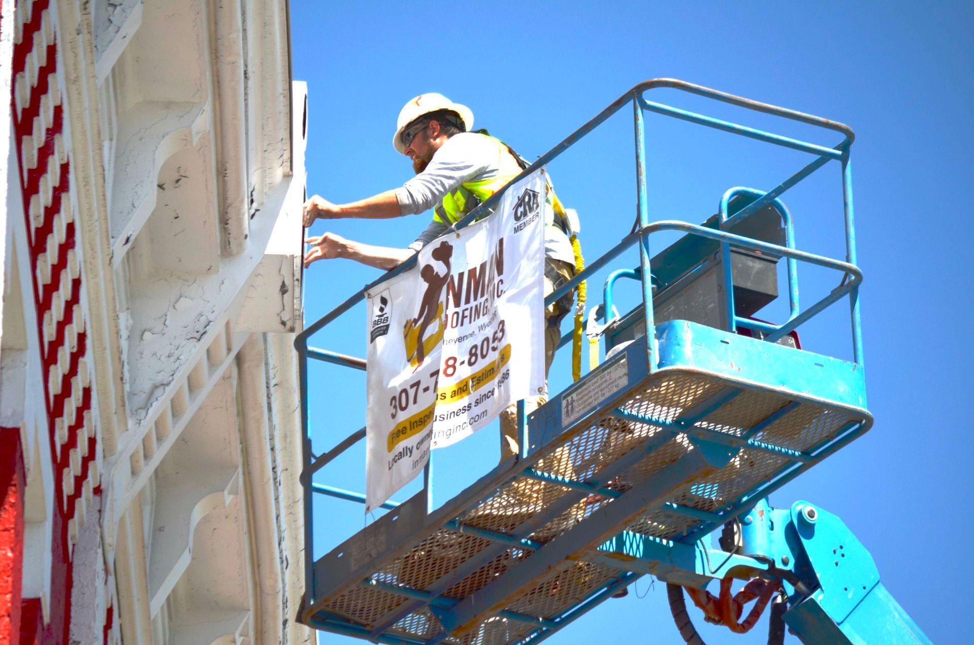 Worker Fixing Signage — Cheyenne, WY — Inman Roofing