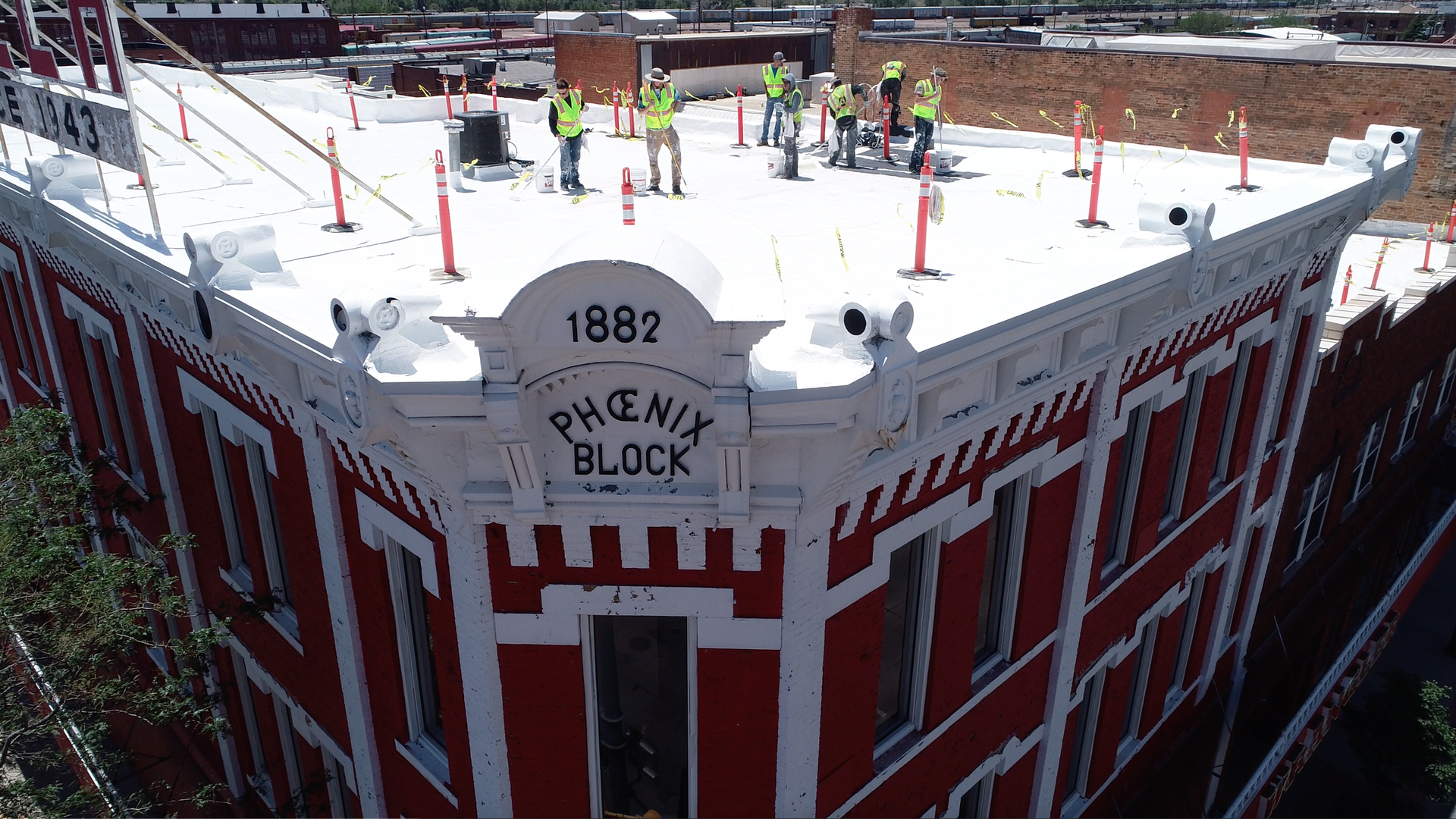 Workers At The Top Of Building — Cheyenne, WY — Inman Roofing