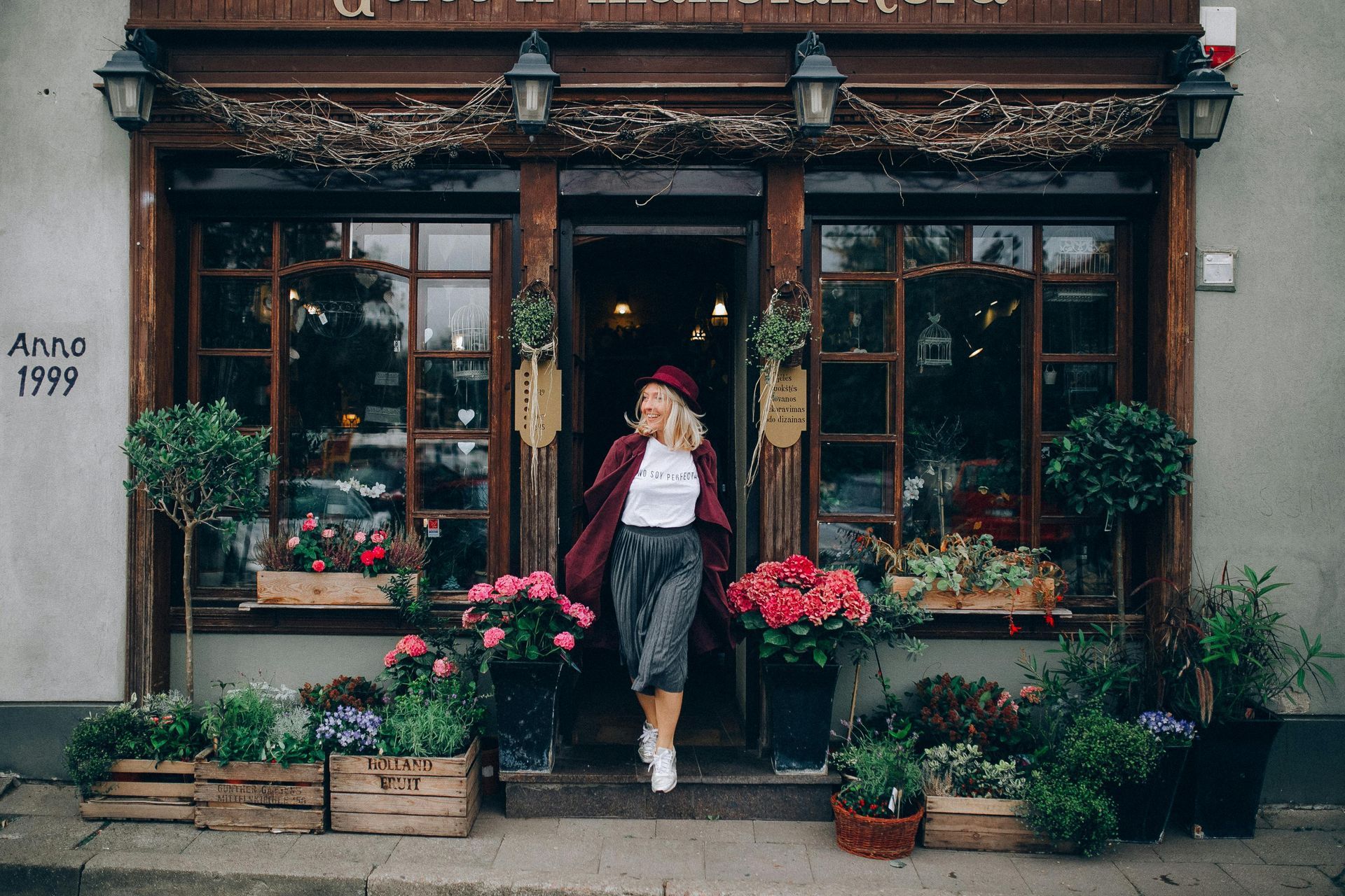 Woman in front of a flower shop. 