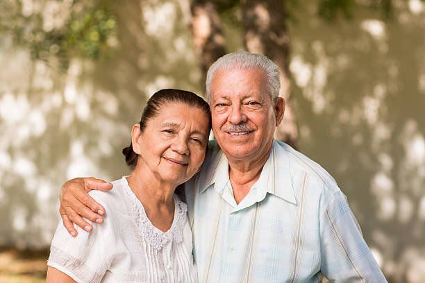 Elderly Hispanic couple embracing eachother