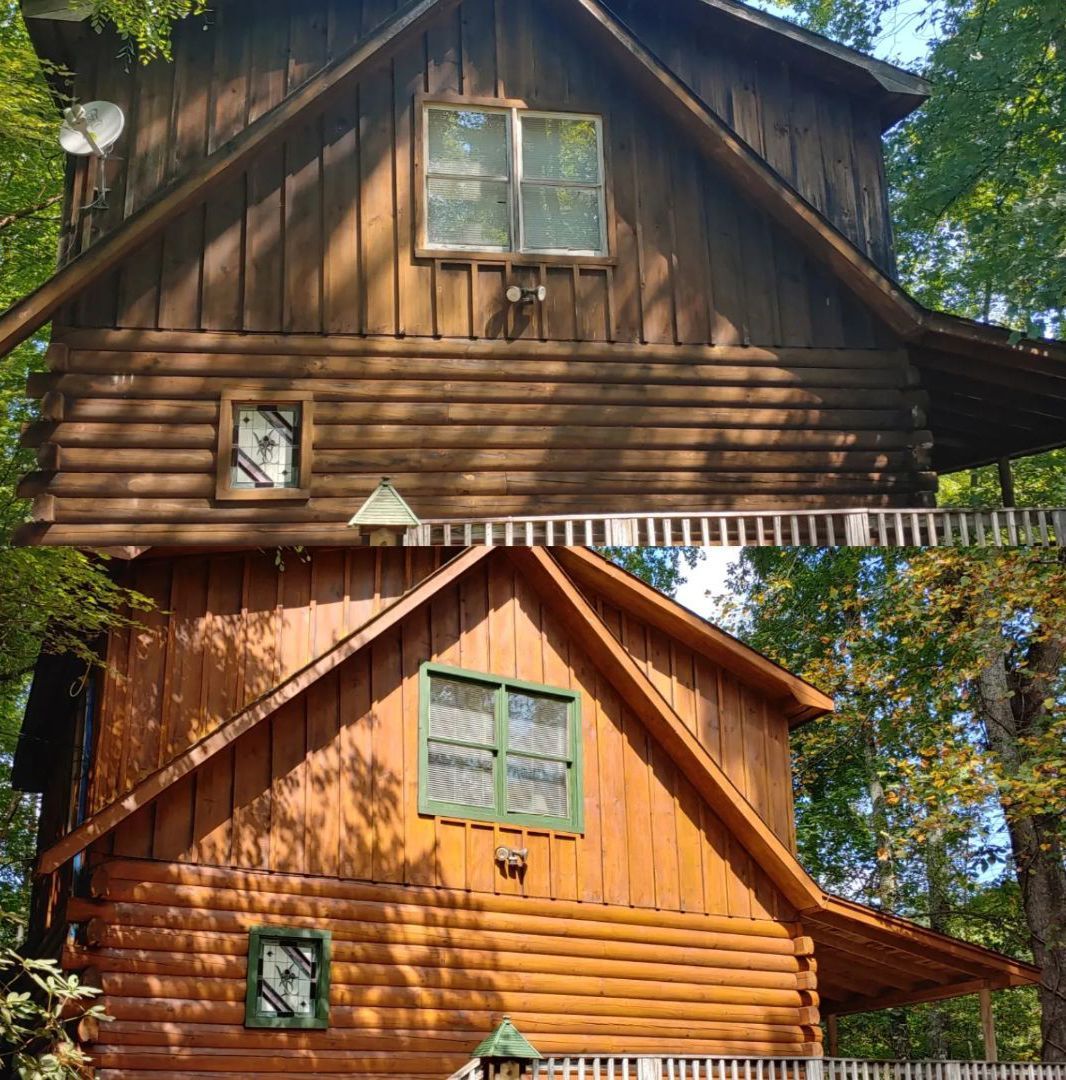 Two-panel photo of a log cabin before and after staining.