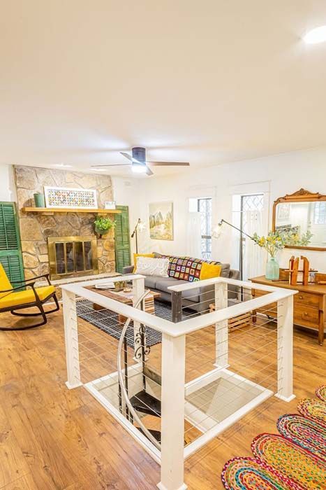 Living room with a glass-topped elevator. 