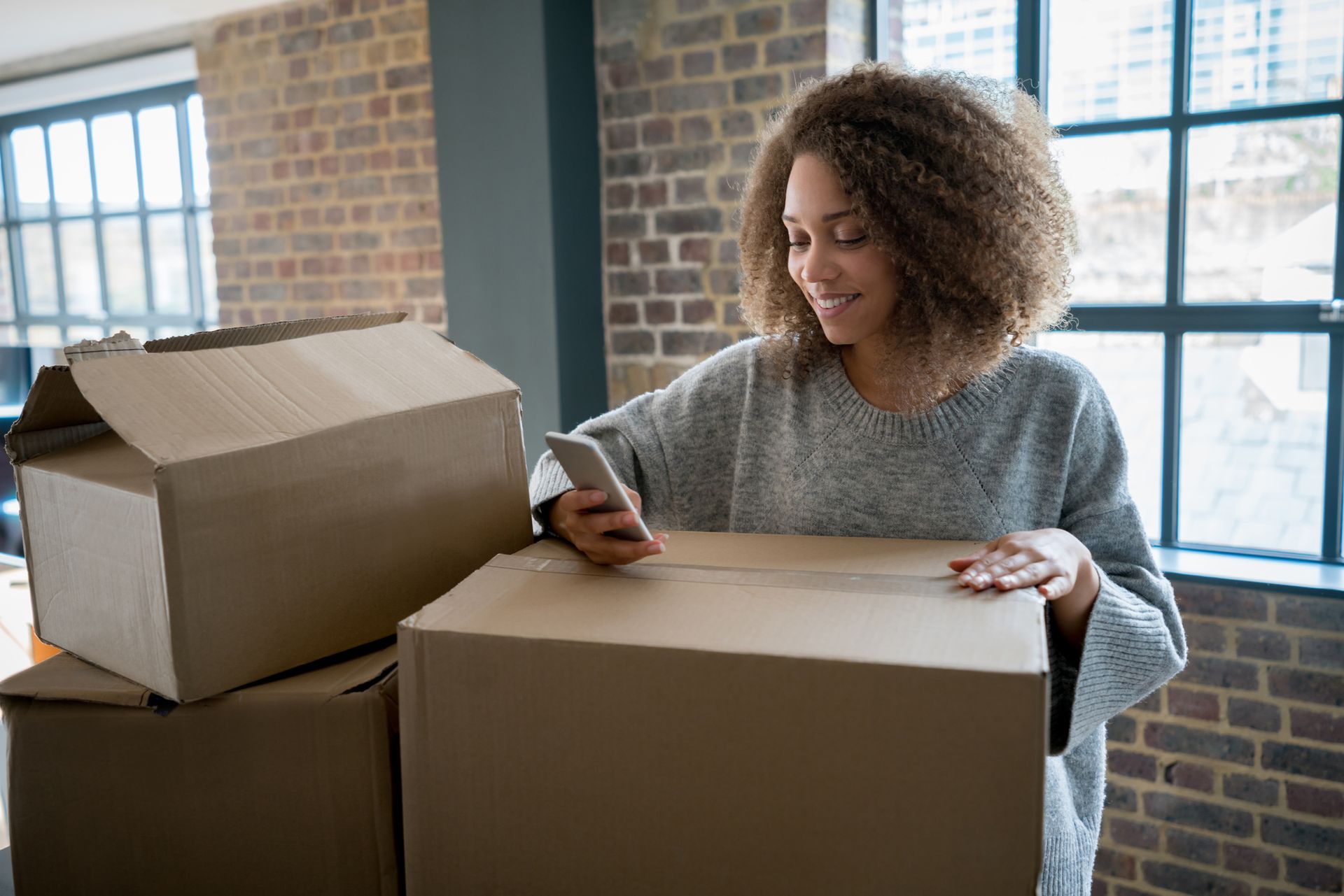 Happy Woman Moving Boxes — Lafayette, LA — Alex Louis Movers