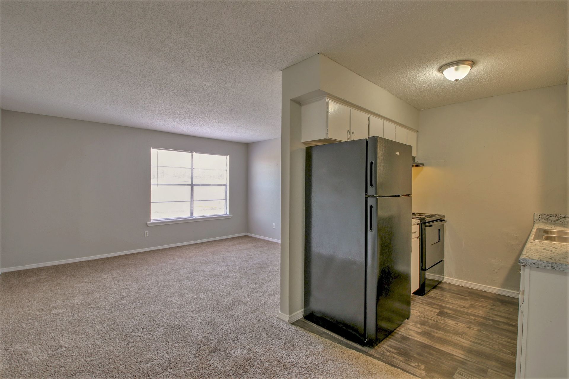 There is a refrigerator in the middle of the room.