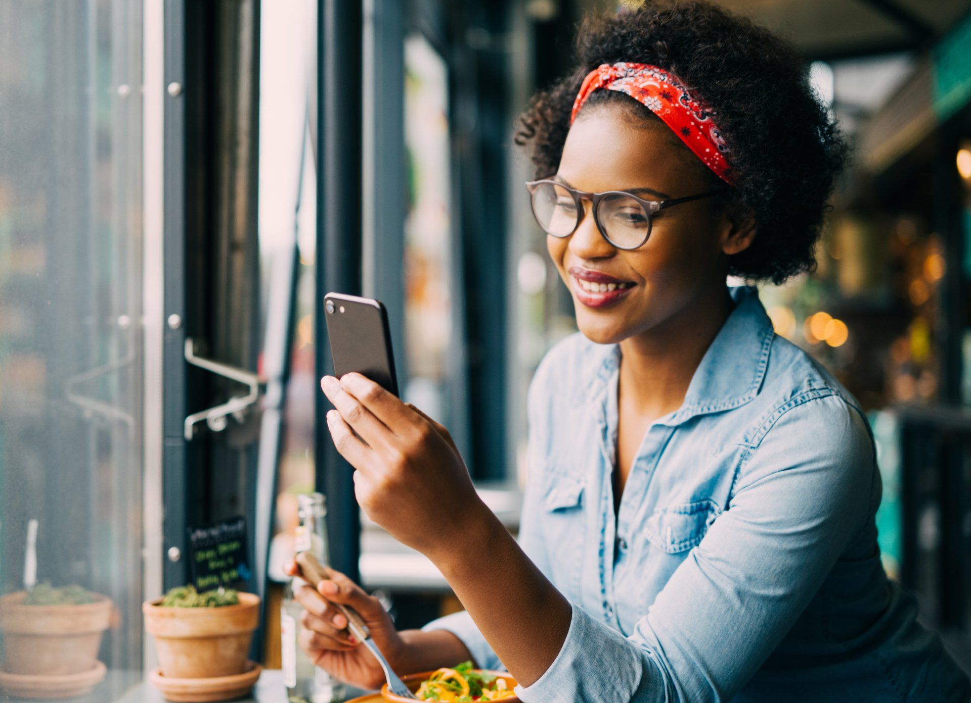 Woman wearing eye wear and working on phone