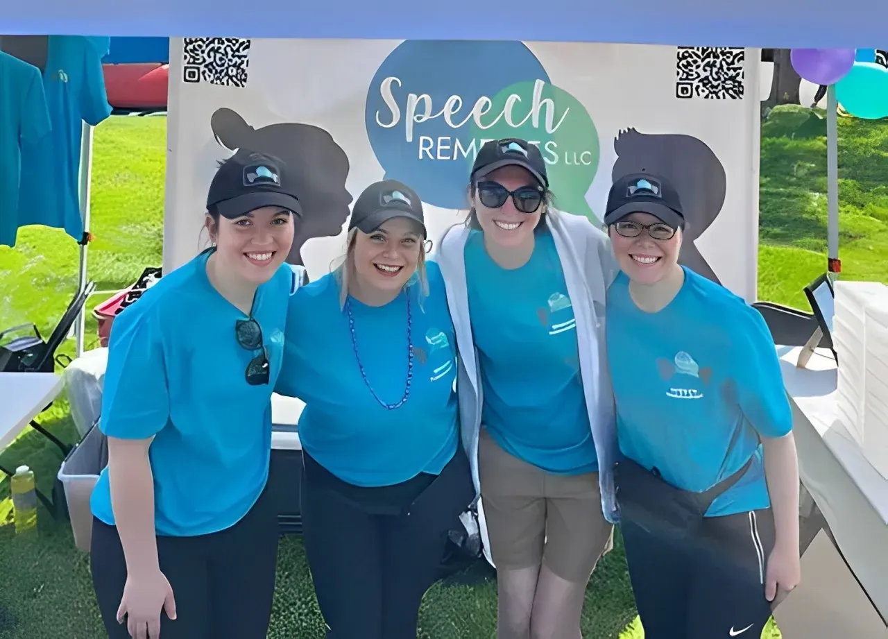 A group of women standing in front of a sign that says speech