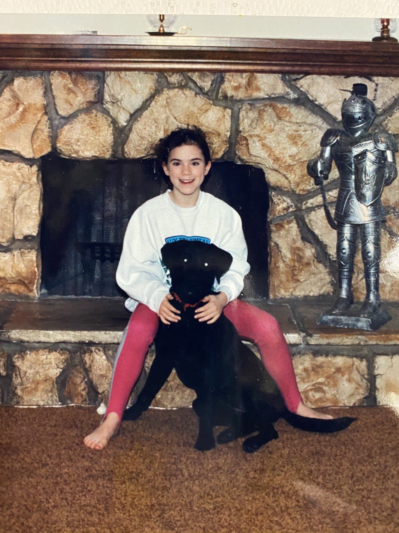 Photo of the author with her lab, Spud, growing up.