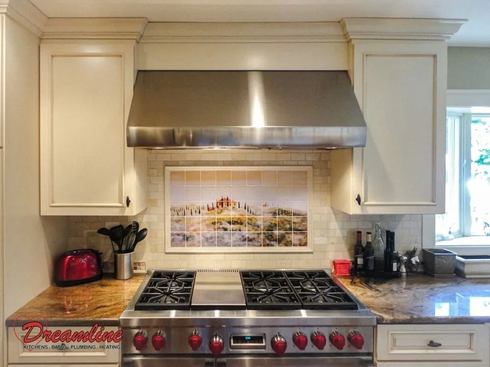 A kitchen with a stove top oven and a picture on the wall above it