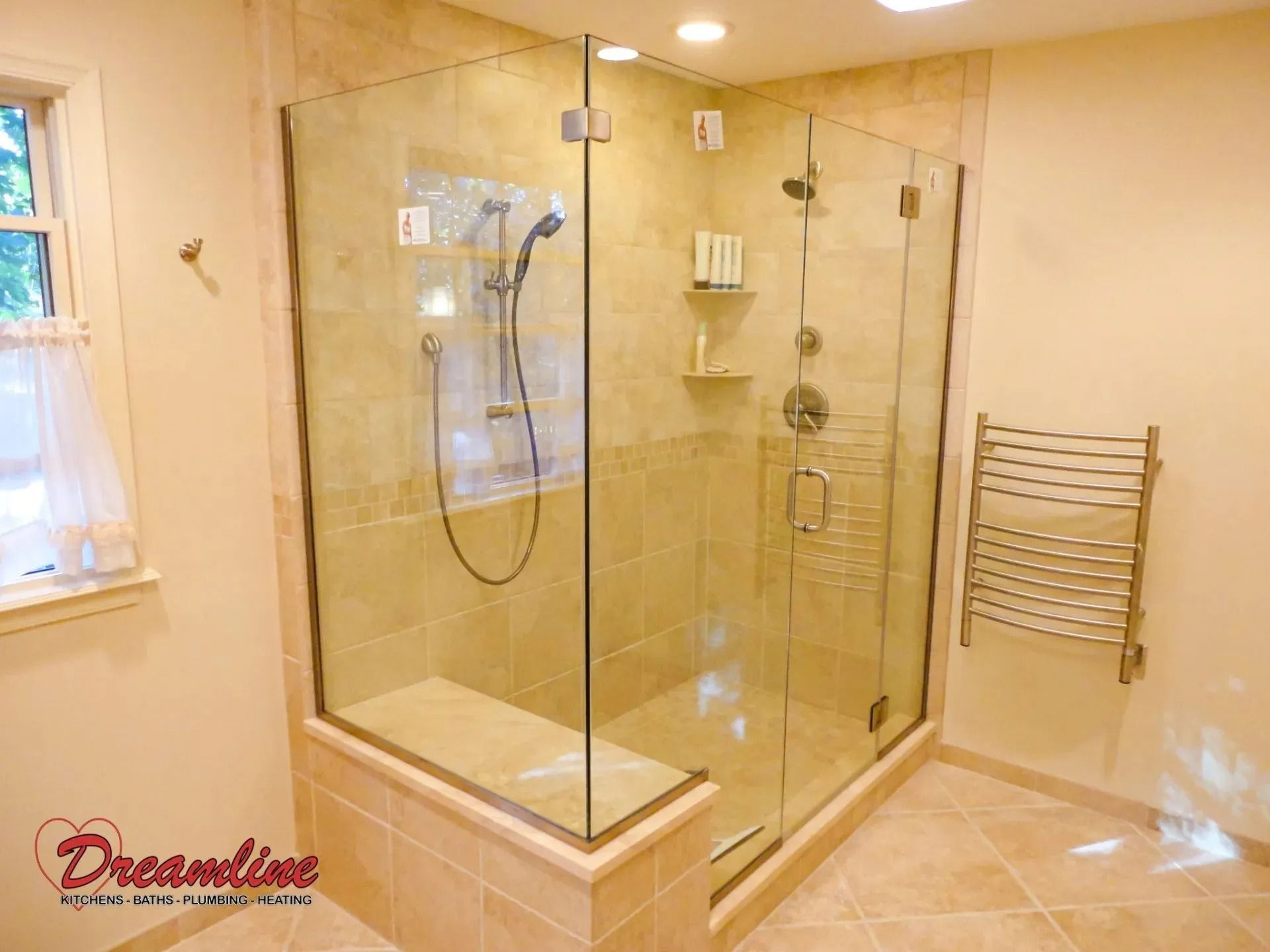 A bathroom with a walk in shower and a towel rack