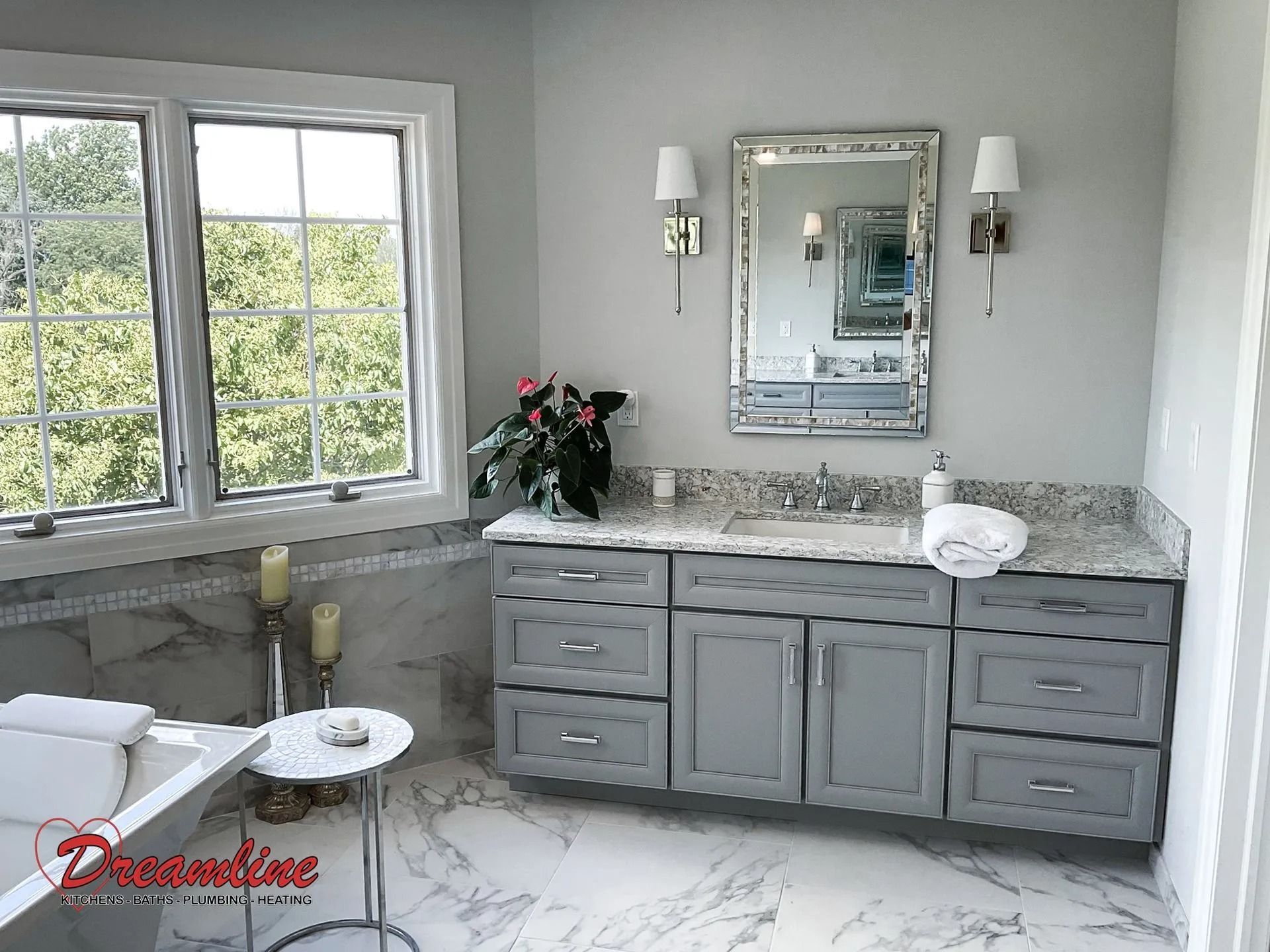 A bathroom with two sinks , a mirror and a window.
