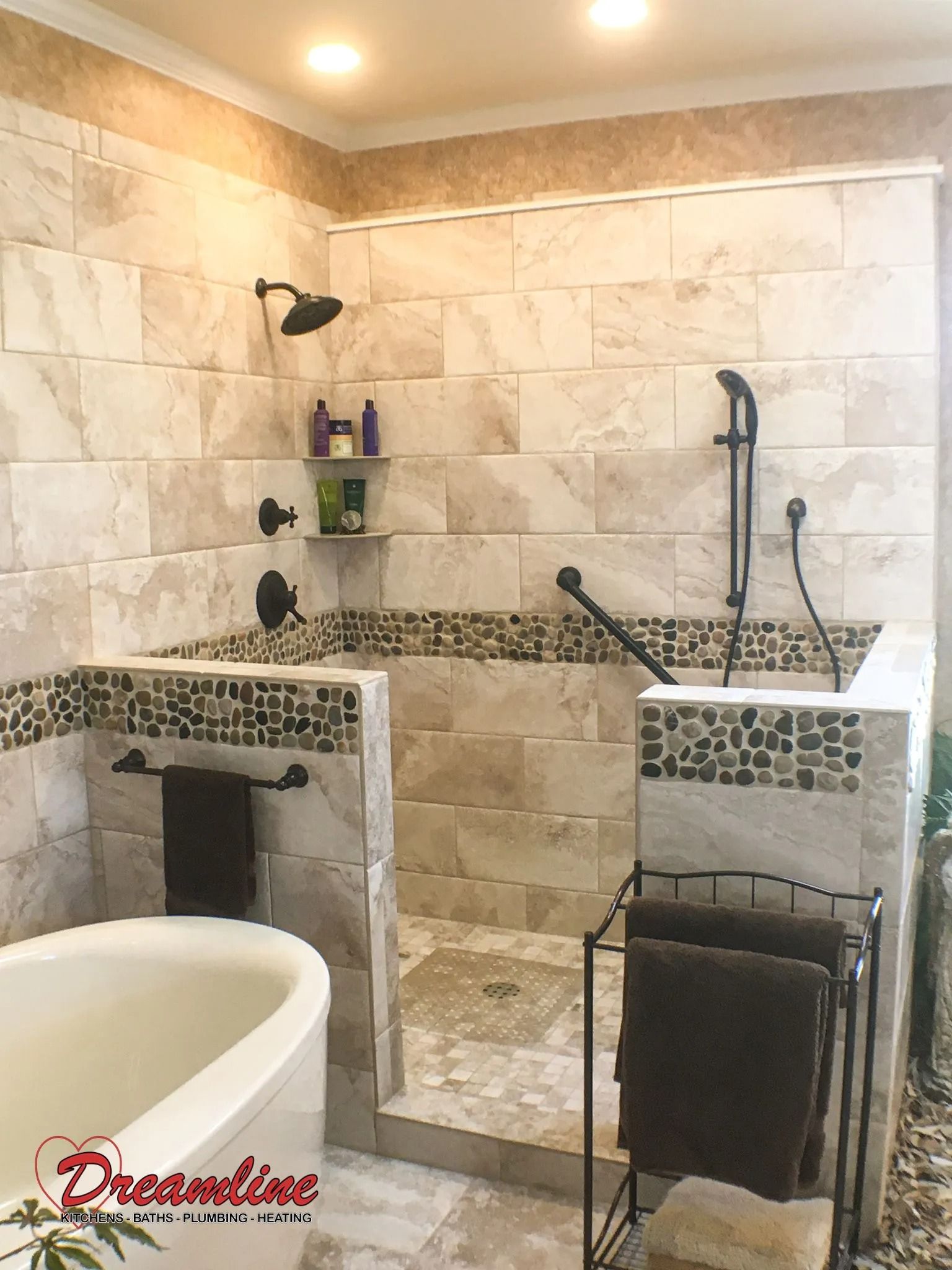 A bathroom with a tub , shower , and towel rack.