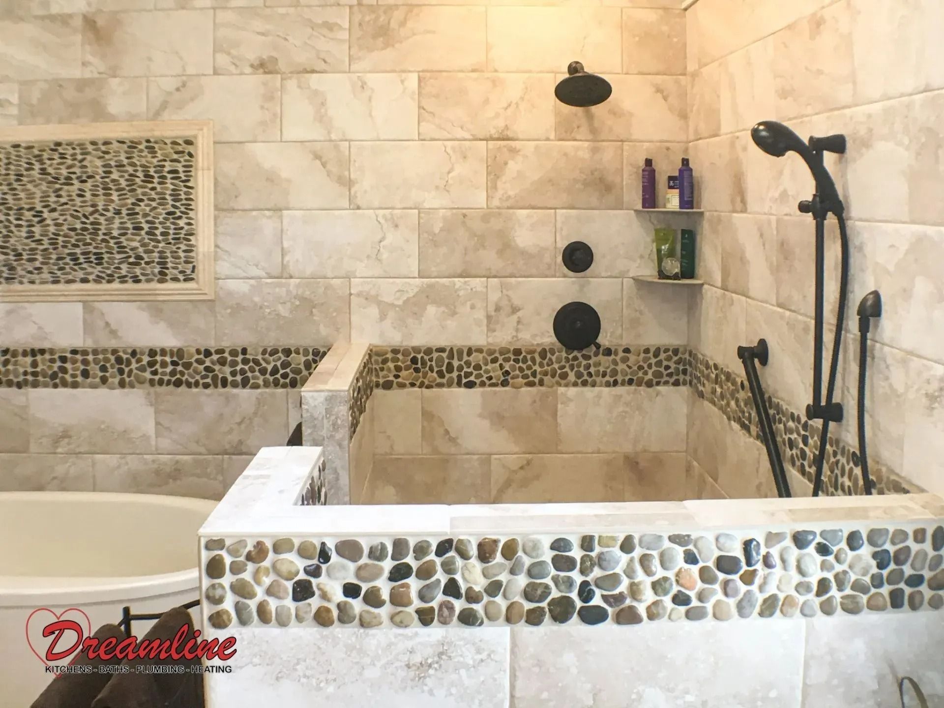A bathroom with a tub , shower , and mosaic tiles.