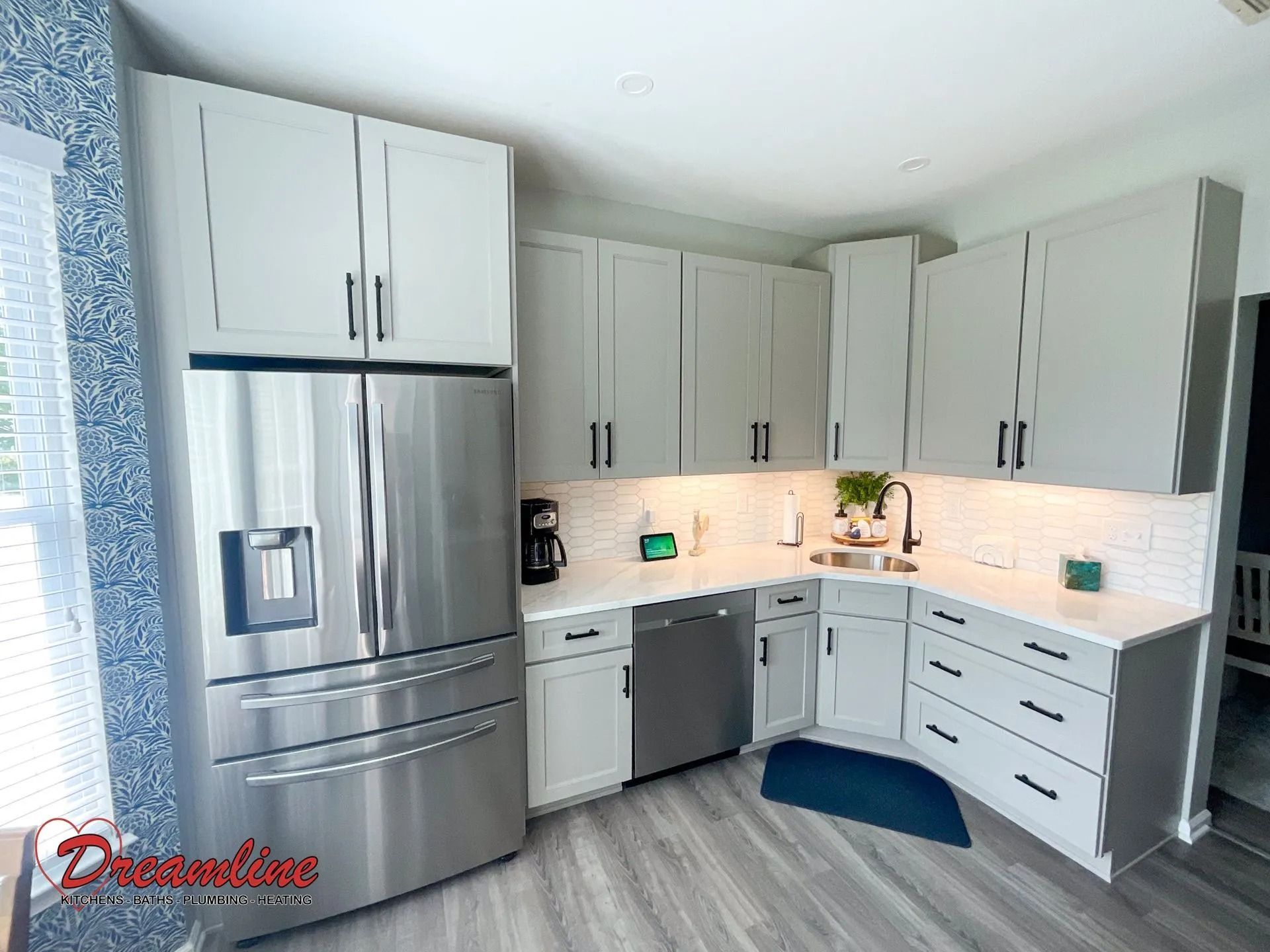 A kitchen with white cabinets and stainless steel appliances.