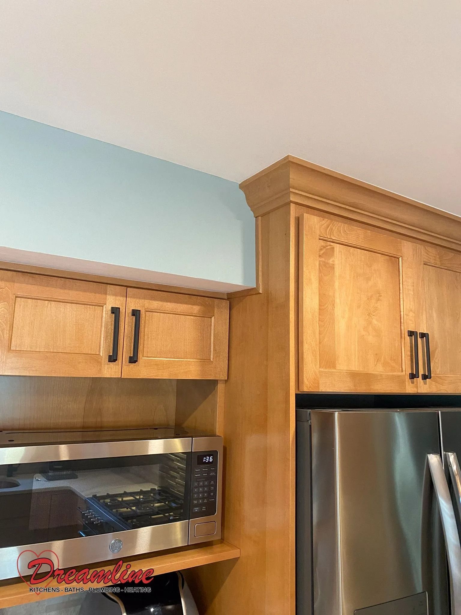 A kitchen with stainless steel appliances and wooden cabinets.