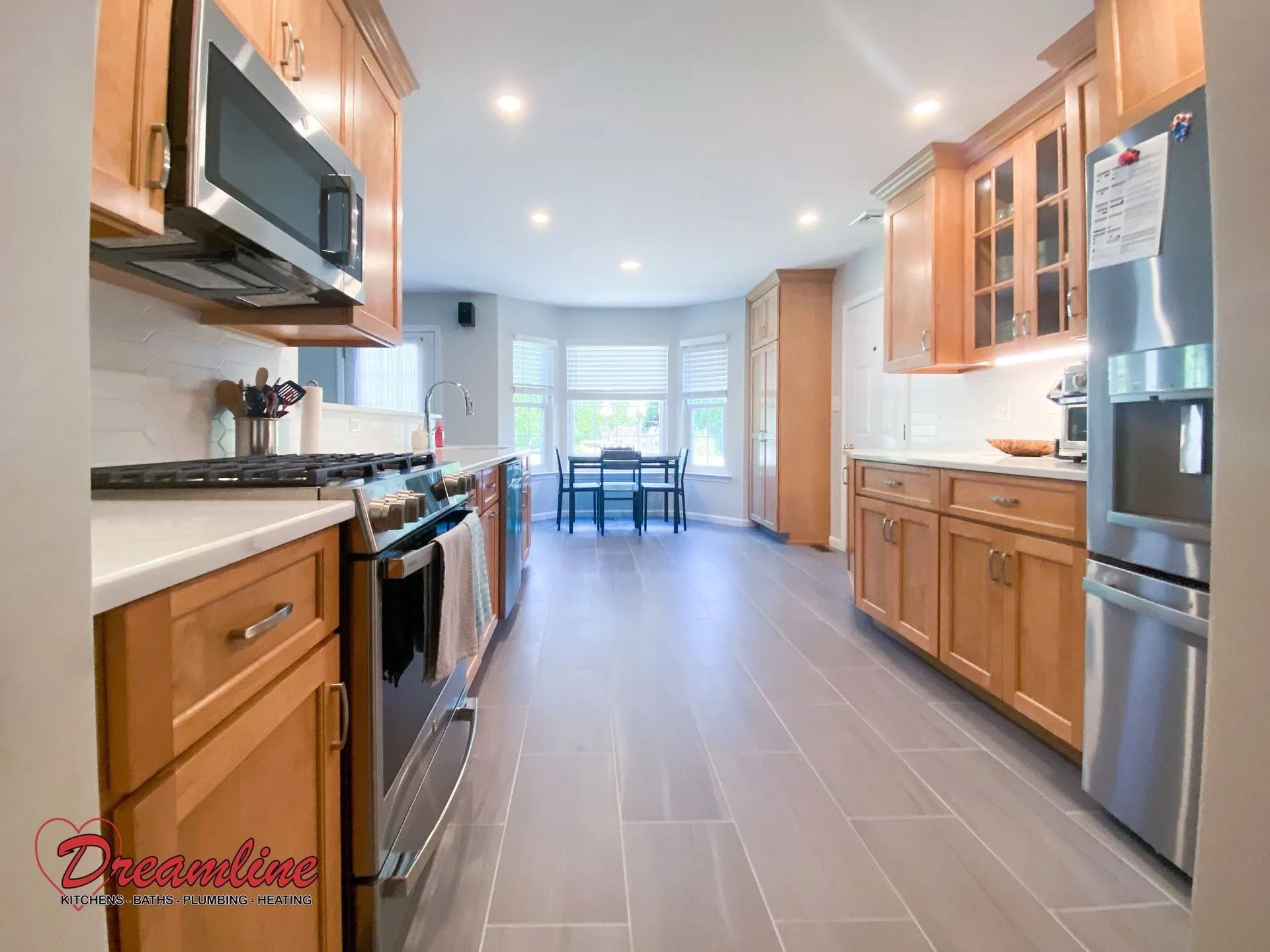A kitchen with stainless steel appliances and wooden cabinets