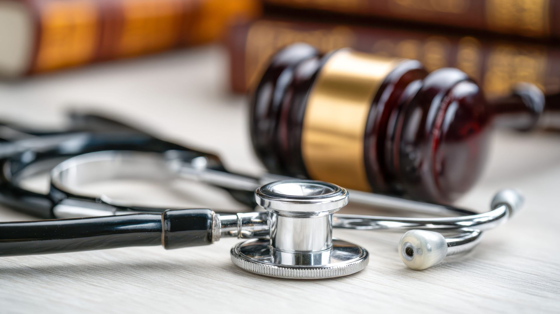 Stethoscope and judge’s gavel on a desk, suggesting medical law or malpractice concept