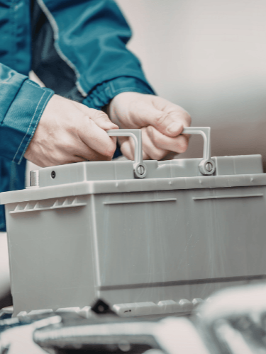 A mobile mechanic doing a battery replacement on-site