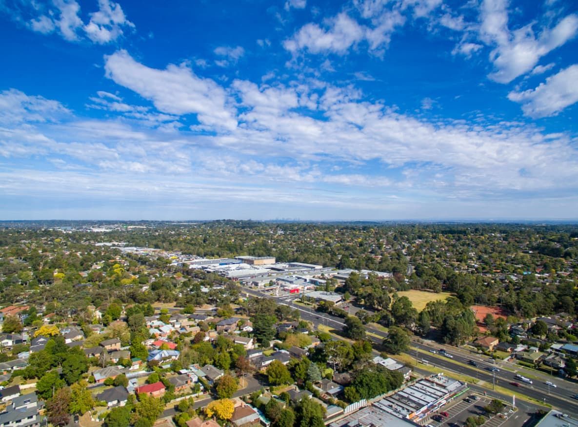 An Aerial View Of A Residential Area With A Blue Sky And Clouds — Point to Point Surveying In Cobram, VIC